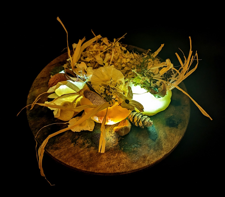 This is an image of a fall centerpiece created with candle wax, LED lights, and fall decor.