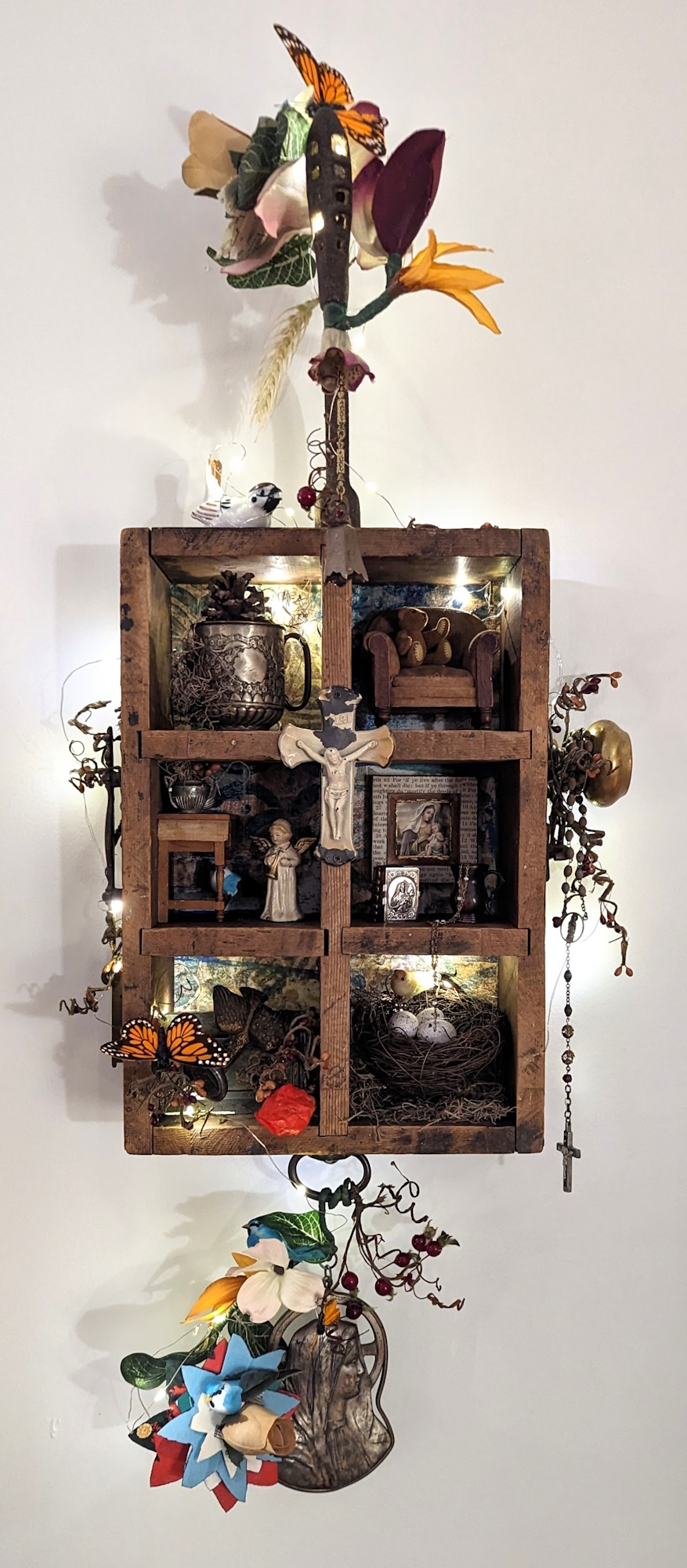 An assemblage sculpture titled 'Story Box', featuring intricate miniatures and spiritual objects, creatively arranged for exploring fantastical realms.